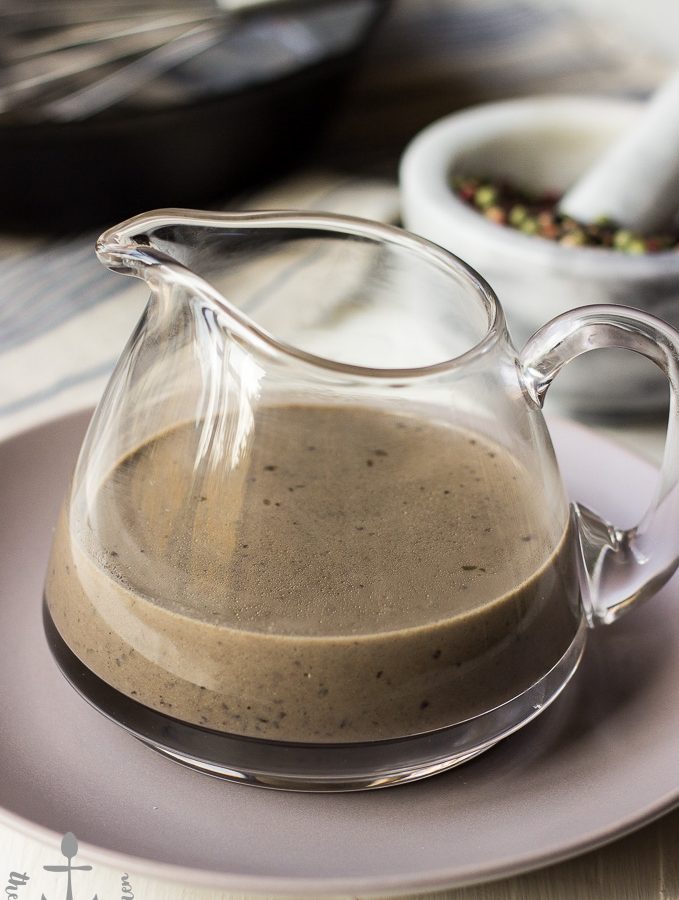 Bourbon Peppercorn Sauce served in a big glass jar on top of a plate