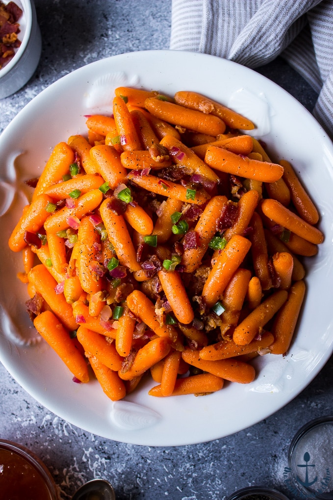 Apricot Glazed Carrots with Bacon and Jalapenos in a white bowl.
