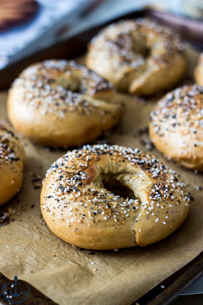 Everything Bagels on baking sheet lined with parchment paper.