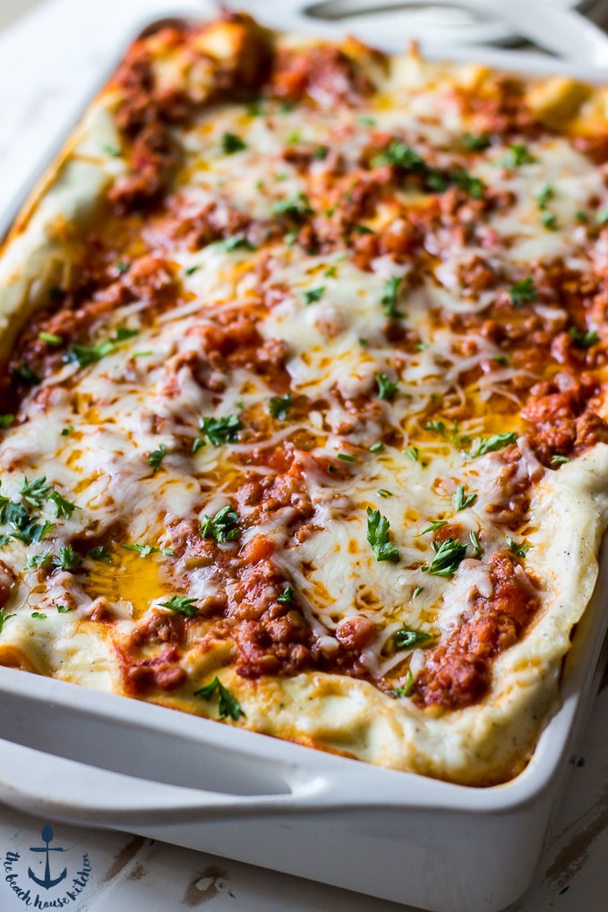 Closeup of the mouthwatering lasagna bolognese in a white baking pan