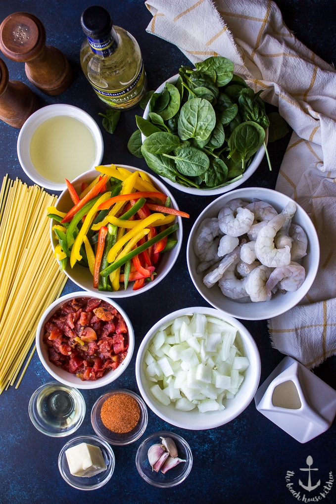 Overhead photo of ingredients for Cajun Shrimp Linguine in individual bowls.