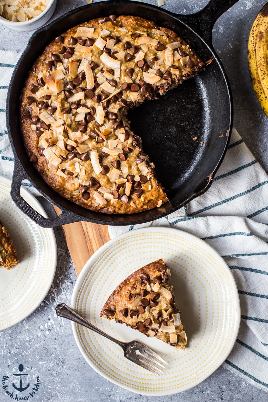 Overhead photo of a skillet of banana bread with chocolate chips and coconut