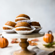 Pumpkin Whoopie Pies with Praline Buttercream on a marble cake stand