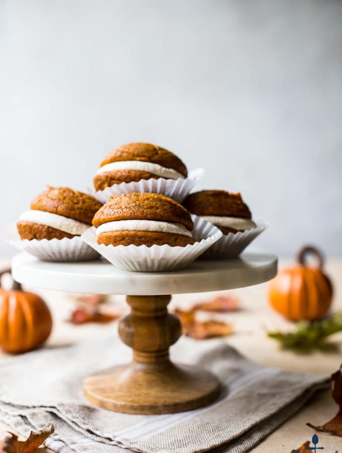 Pumpkin Whoopie Pies with Praline Buttercream on a marble cake stand