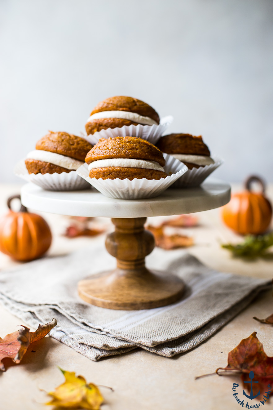 Pumpkin Whoopie Pies with Maple Buttercream on a marble cake stand