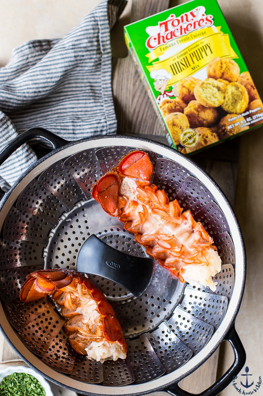 Overhead photo of lobster tails in strainer and box of hush puppy mix
