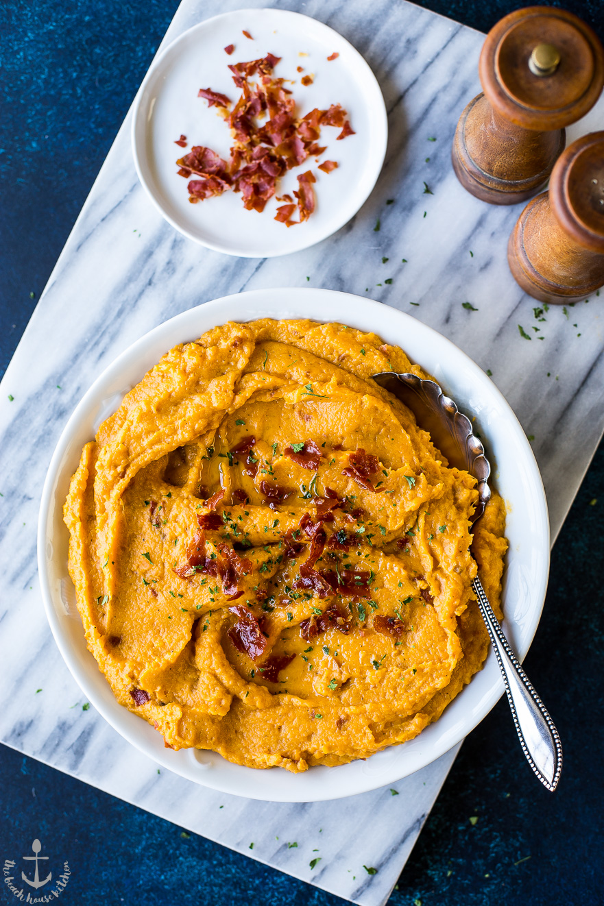 Overhead photo of mashed sweet potatoes topped with crsipy proscuitto