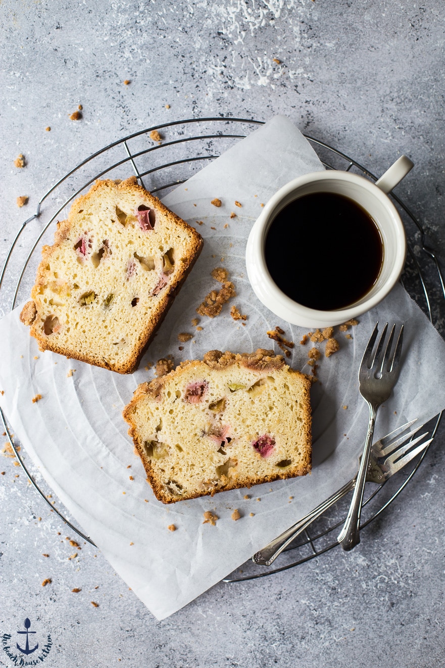 Overhead photo of slices of rhubarb crumb loaf, cup of coffee and forks