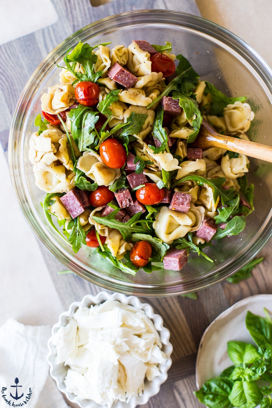 Overhead photo of Tortellini, Roasted Tomato and Salami Salad in a clear bowl