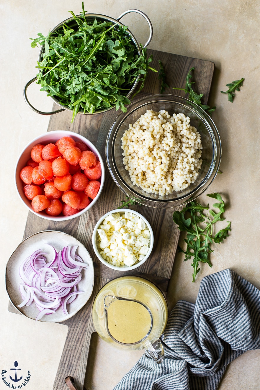 Ingredients for watermelon, feta couscous salad in individual bowls