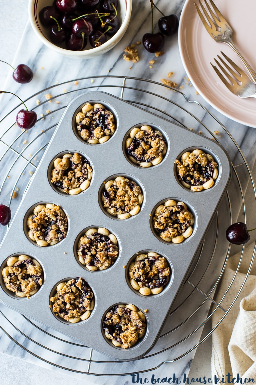 Overhead photo of streusel topped cherry pie bites in a mini muffin tin