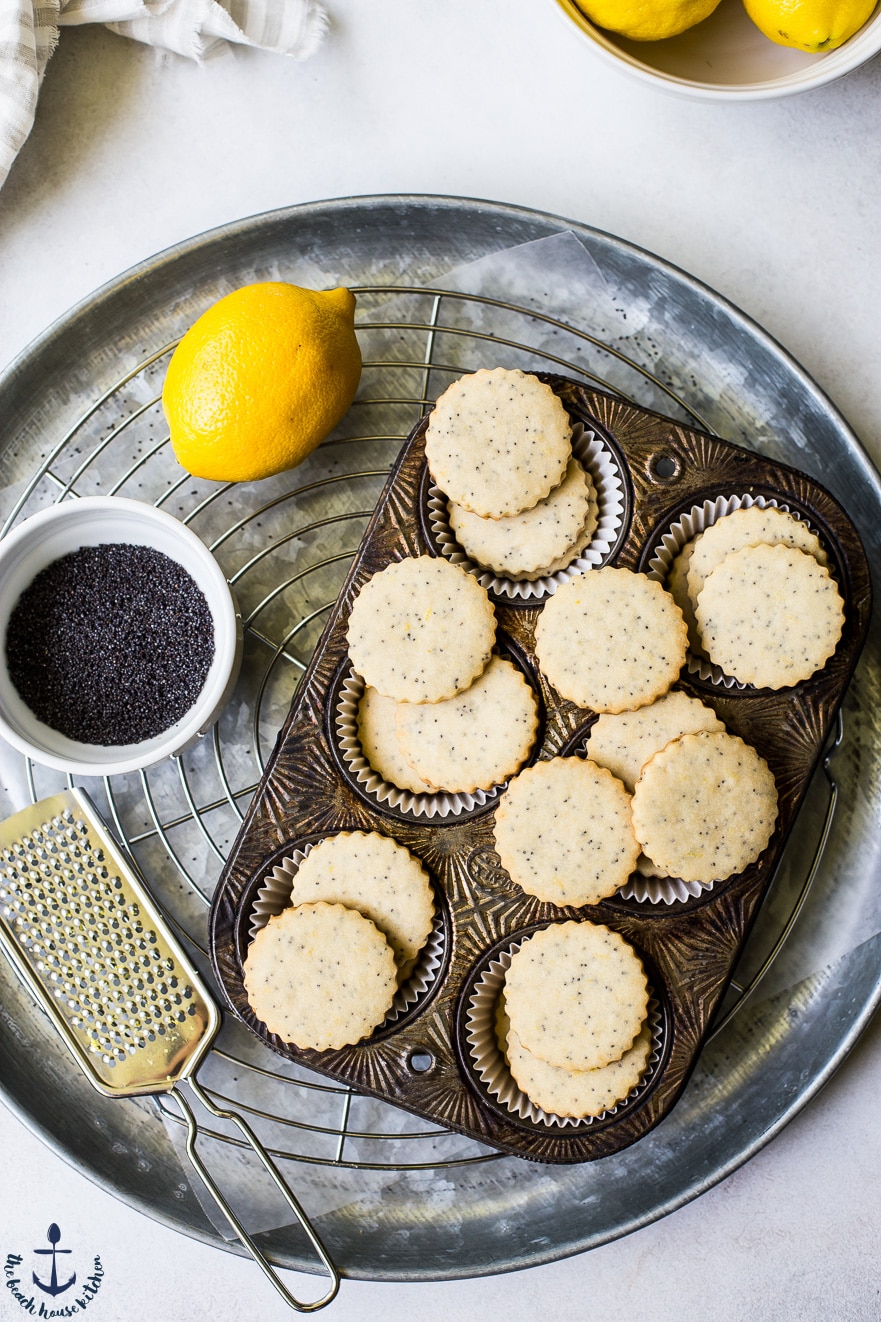 Overhead phhoto of muffin tin filled with lemon poppyseed shortbread cookies.