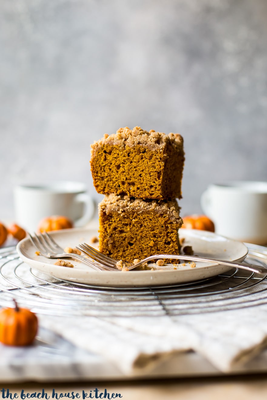 Stack of two slices of pumpkin crumb snack cake on a plate