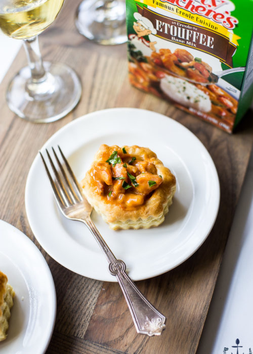 A shrimp etouffee vol au vent on a white plate with a fork