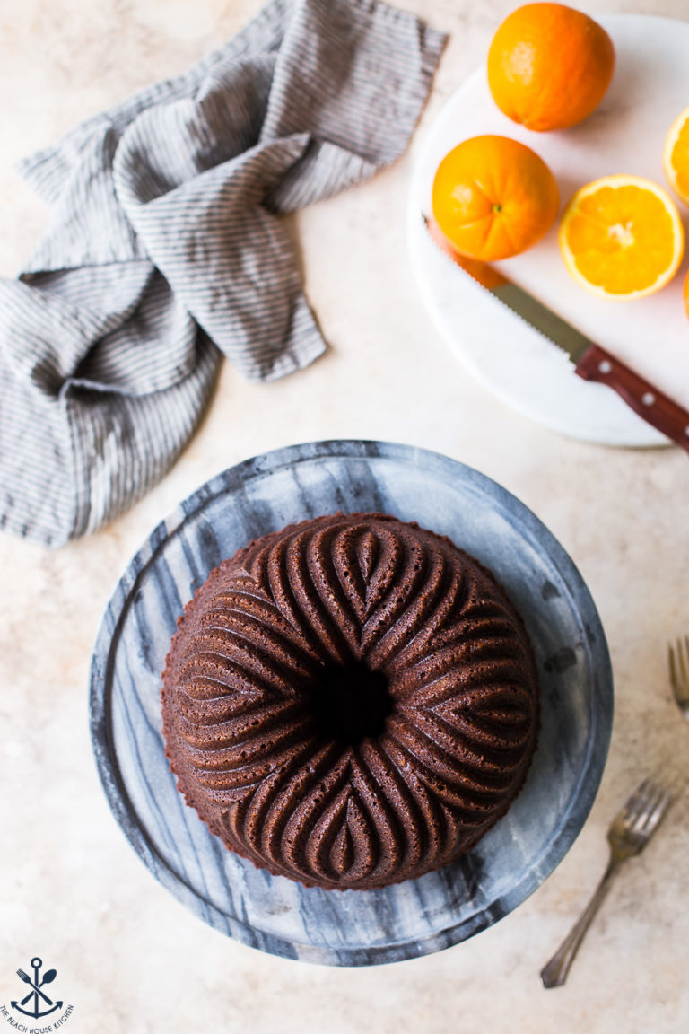 Overhead photo of a chocolare orange bundt cake on a marble cake plate