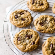 Six Almond Joy Chocolate Chip Cookies on a round wire cooling rack