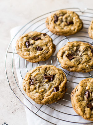 Six Almond Joy Chocolate Chip Cookies on a round wire cooling rack
