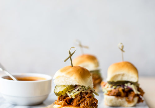 Hot honey pulled chicken sliders on a marble board