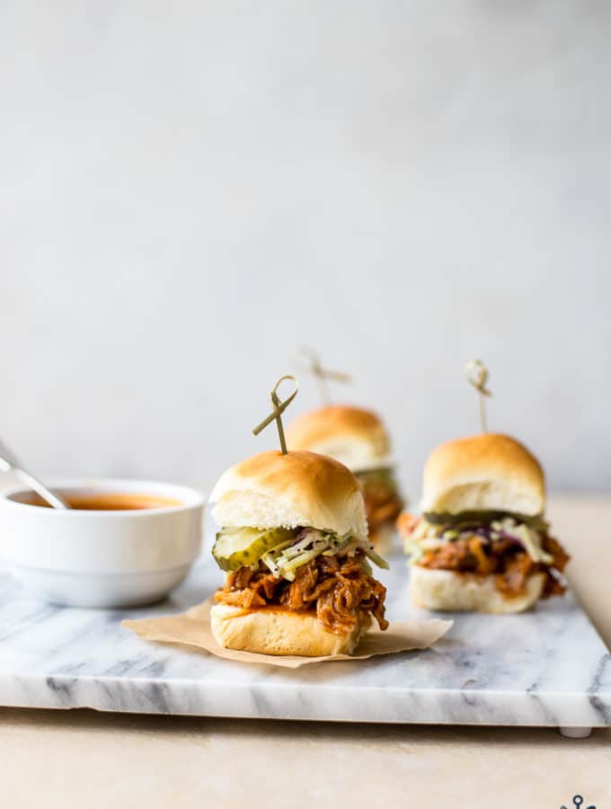 Hot honey pulled chicken sliders on a marble board