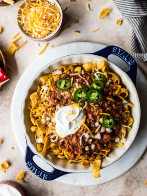 Overhead photo of frito pie in a round blue baking dish