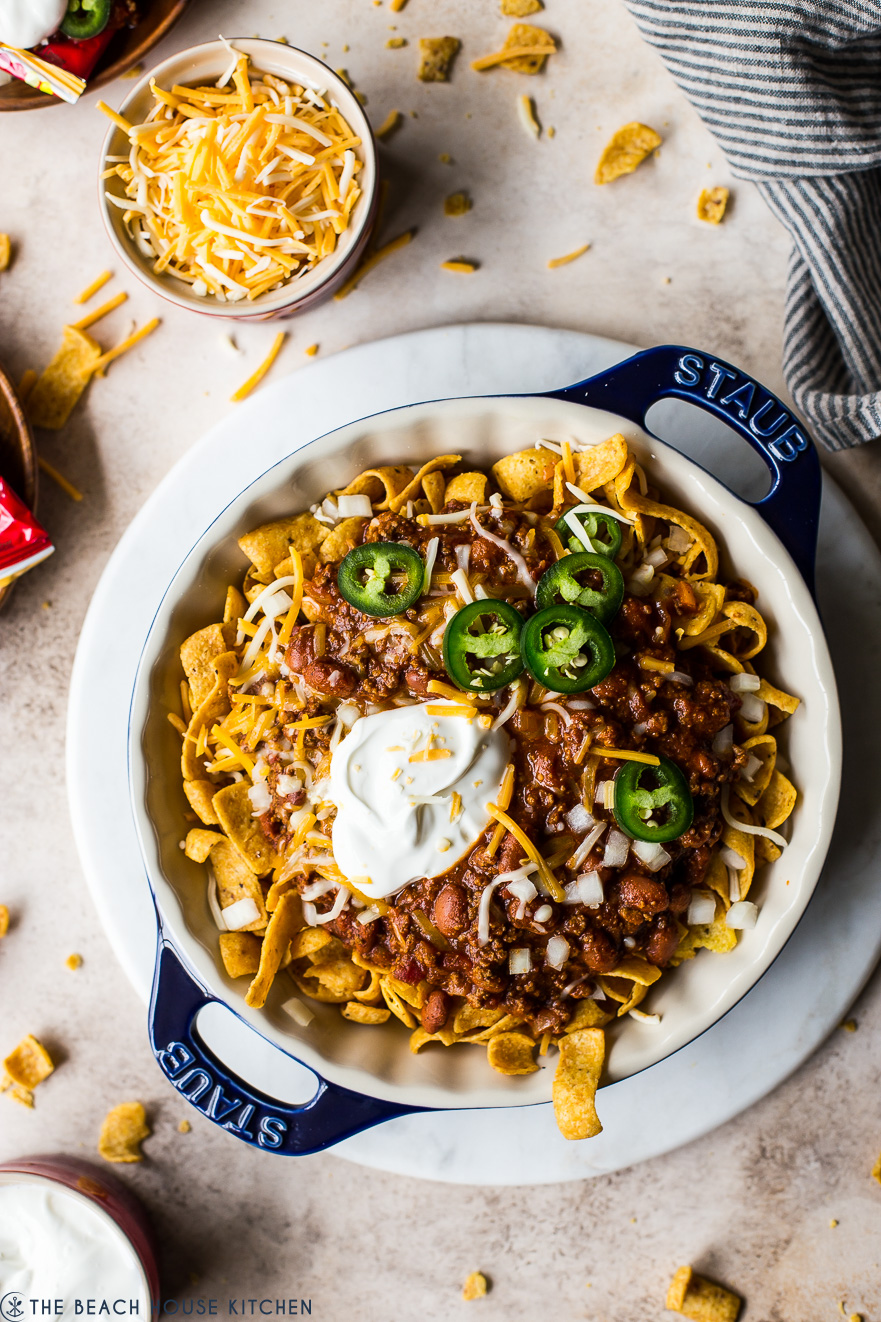 Overhead photo of a round blue baking dish filled with frito pie