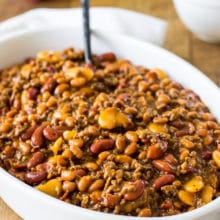 Baked Three Bean Casserole in a white oval dish