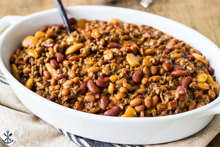 Baked Three Bean Casserole in a white oval baking dish