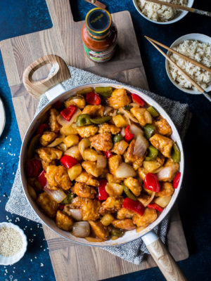 Overhead photo of Sweet and Sour Chicken in a white skillet