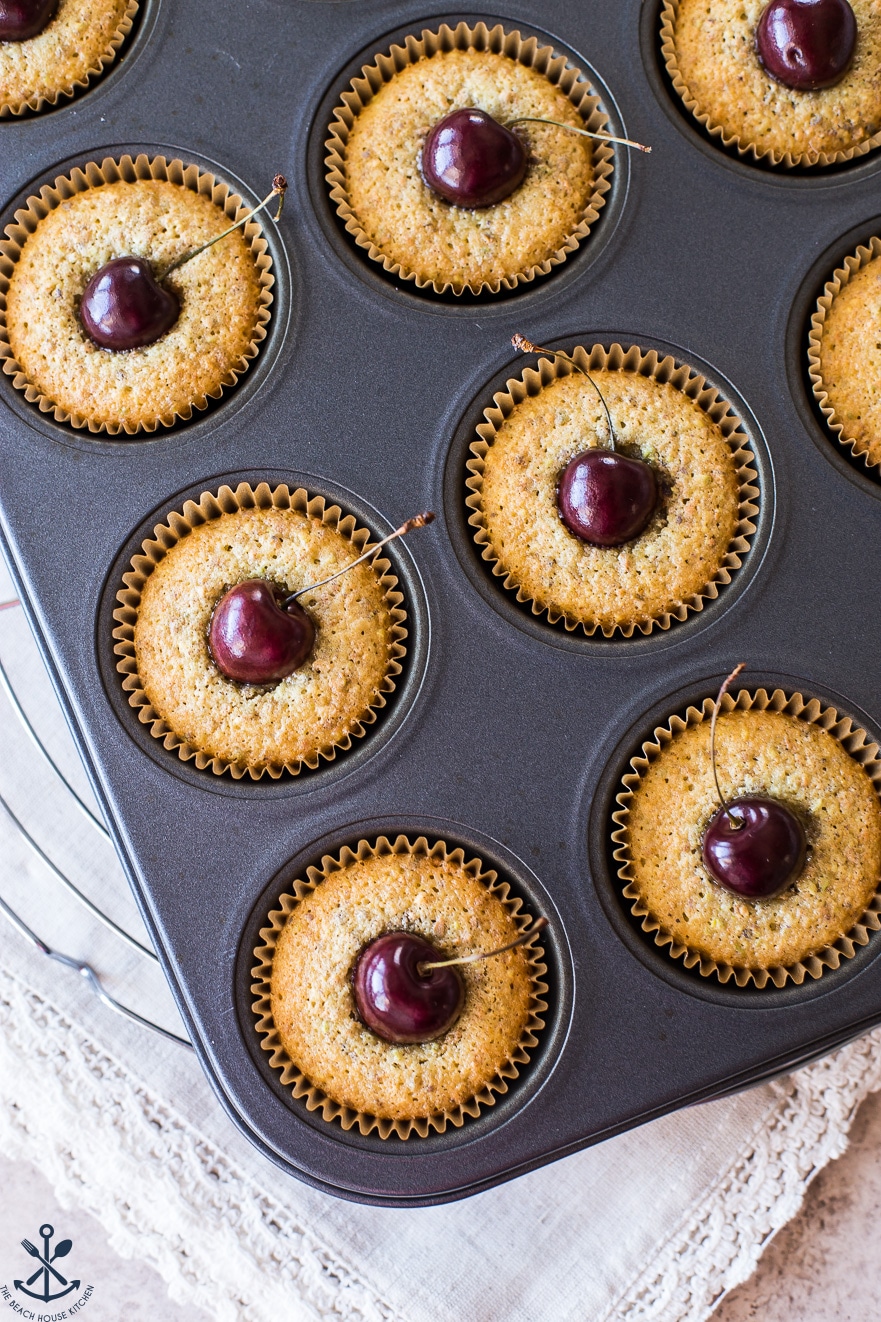 Overhead photo of muffin tin with sweet cherry pistachio tea cakes