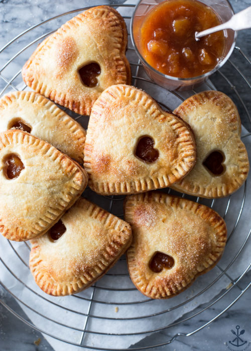 Overhead photo of peach hand pies on a round wire rack