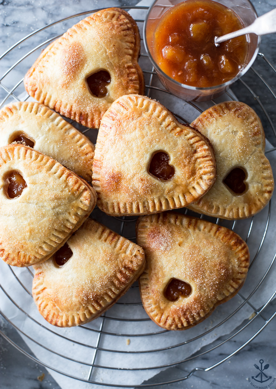 Overhead photo of peach hand pies on a round wire rack