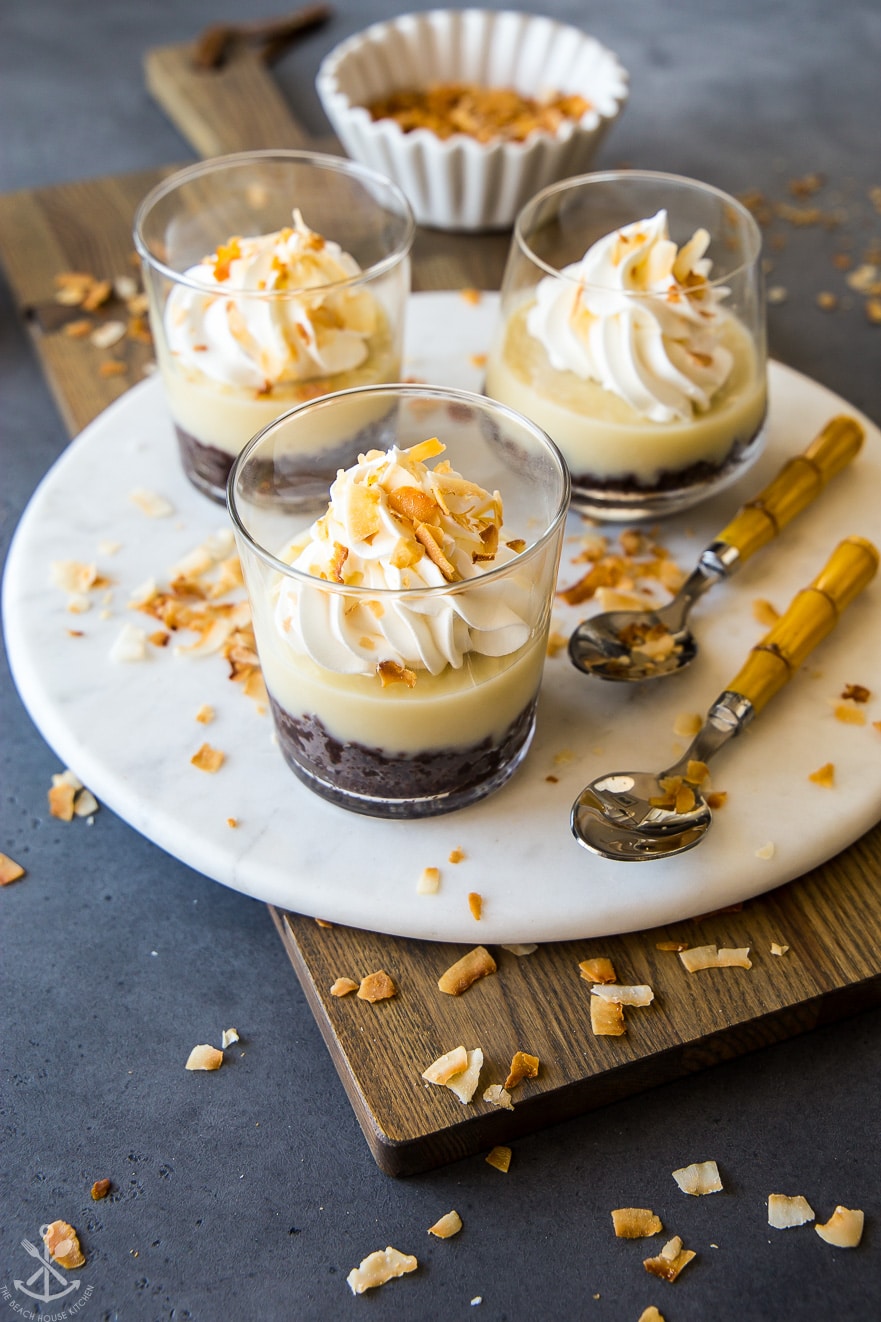 Coconut cream pie parfaits on a round marble board