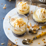 Coconut cream pie parfaits on a round white marble board