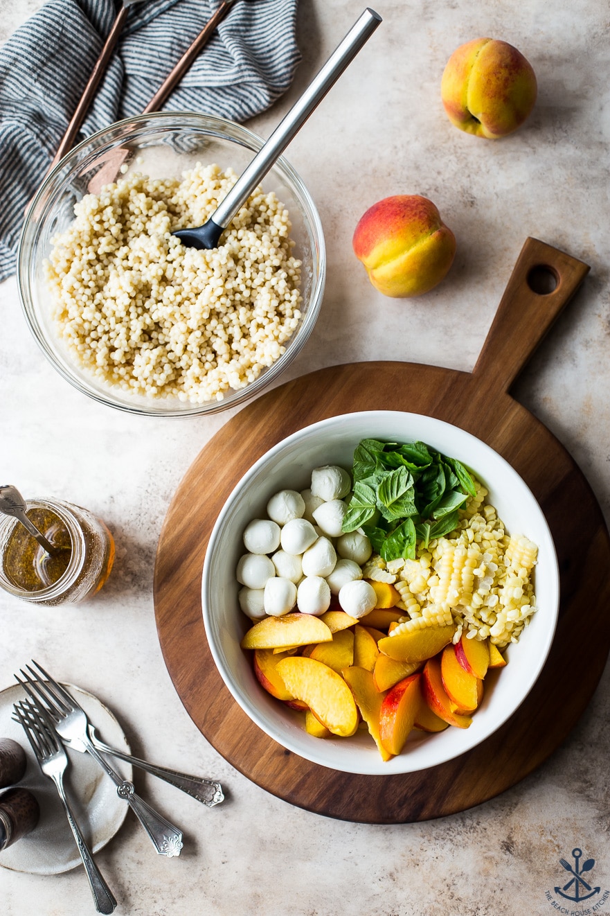 Overhead photo of ingredients for Peach Corn Caprese Couscous Salad in two bowls 