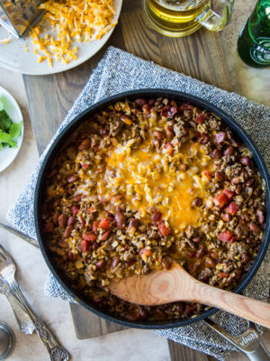 Overhead shot of the delicious Beef Burrito Skillet made in a skillet with a wooden spoon inside