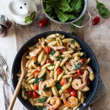 Overhead photo of skillet filled with Shrimp Pasta with Garlic Cream Sauce Tomatoes and Spinach