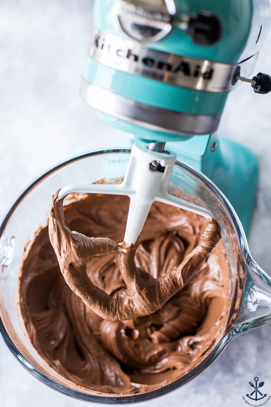 Chocolate cake batter in a turquoise colored KitchenAid mixer