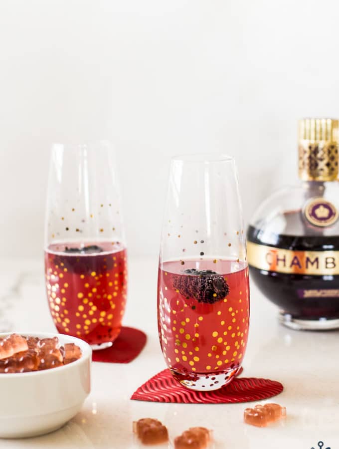 Up close photo of Chambord Fizz and Gummies with a bottle of Chambord in the background