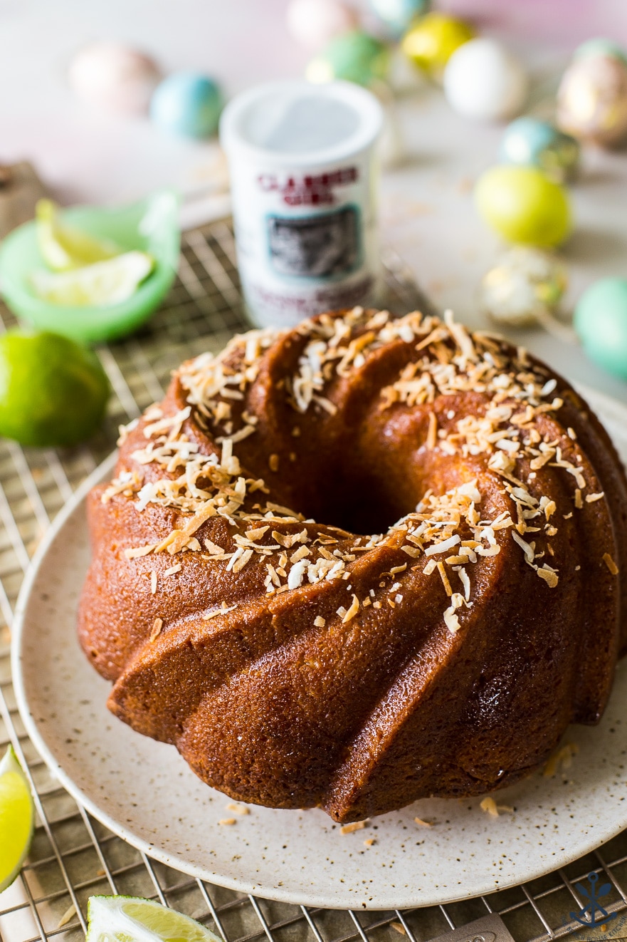 Closeup of the delicious Key Lime Coconut Bundt Cake on a plate on a wire rack