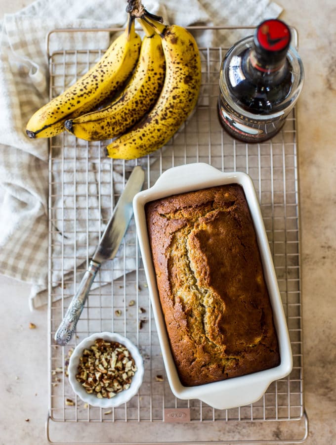Overhead photo of Boozy Banana Bread in a loaf pan on a wire rack