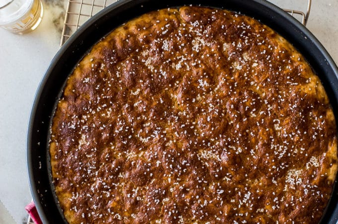 Overhead photo of pretzel focaccia in a round baking pan