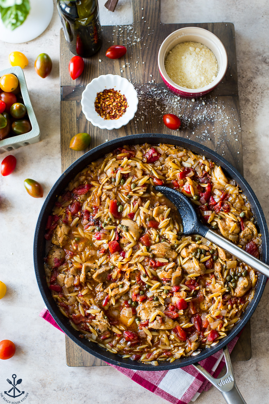 Up close overhead photo of chicken and orzo meal in a skillet
