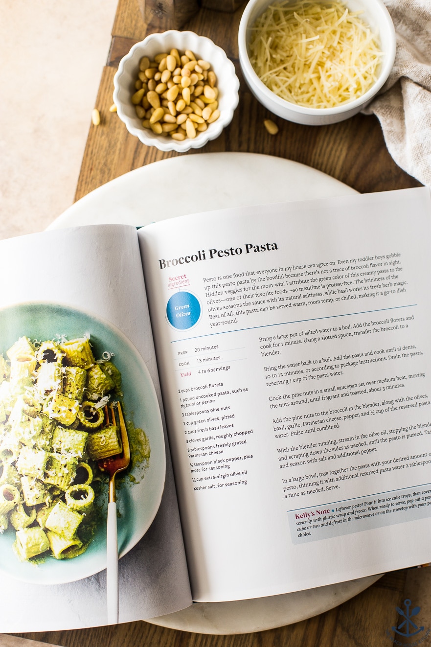 Overhead photo of cookbook open to the page with Broccoli Pesto Pasta recipe