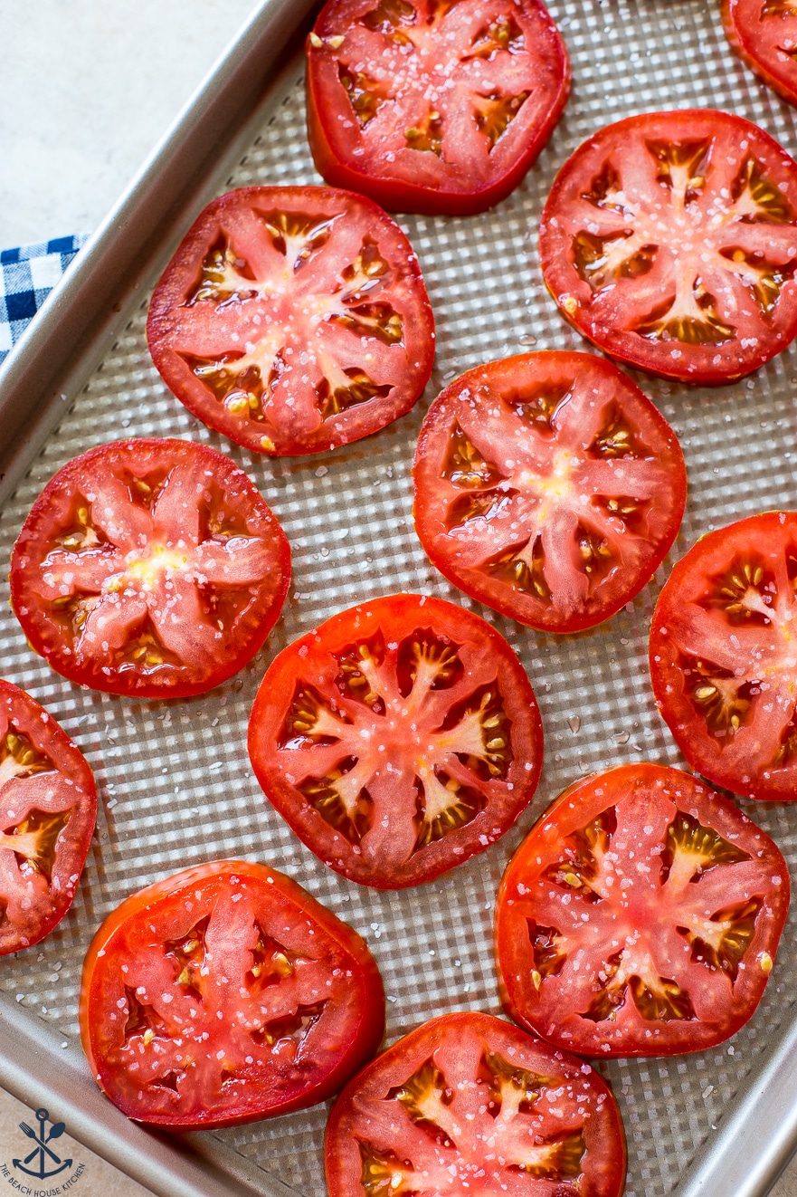 Overhead photo of sliced tomatoes on baking sheet