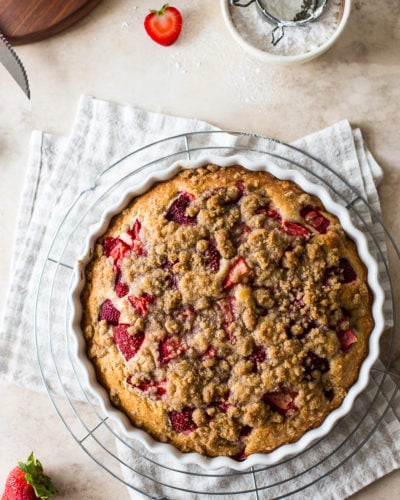 Up close overhead photo of a strawberry buckle in a round white baking dish.