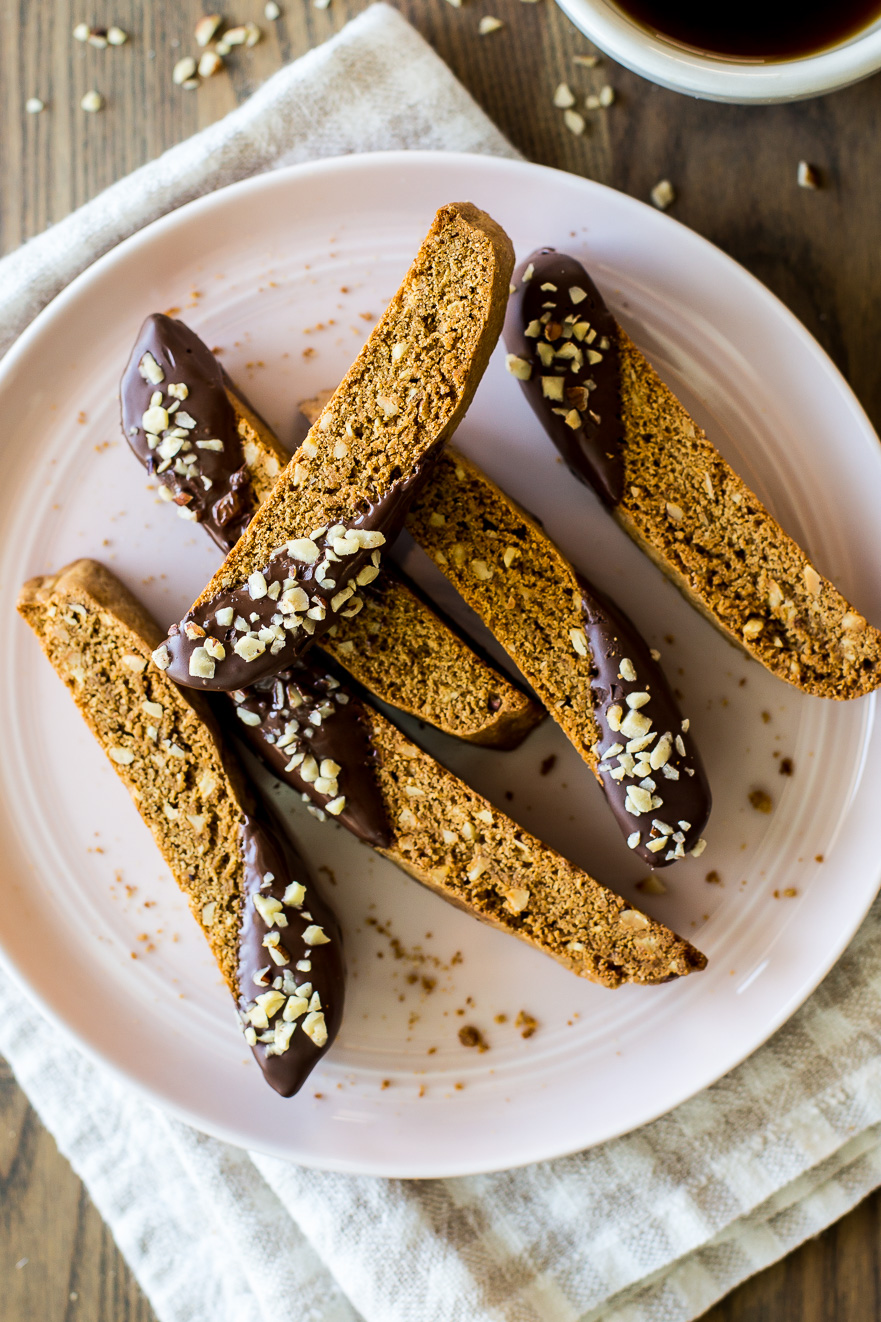 Slices of Chocolate Dipped Hazelnut Espresso Biscotti on a pink plate