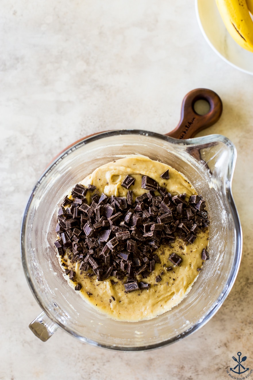 Overhead photo of a bowl filled with cookie batter and chocolate chunks