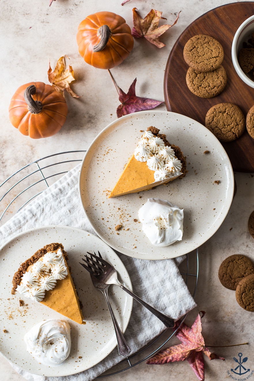 Overhead photo of two plates with slices of pumpkin pie
