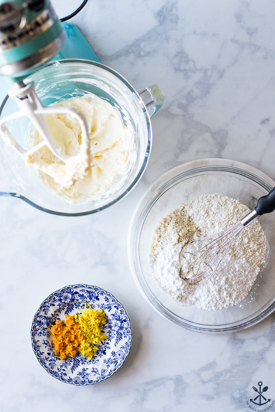 Overhead photo of a mixer, a bowl of flour and a plate of orange and lemon zest