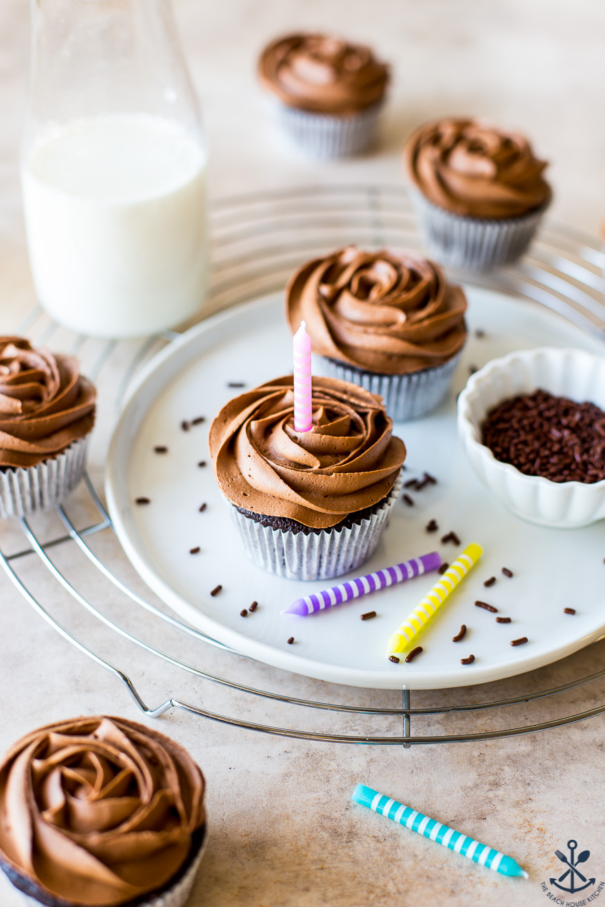A white plate of chocolate cupcakes